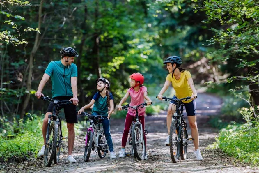 Family cycling on a forest trail — outdoor activities in Greece